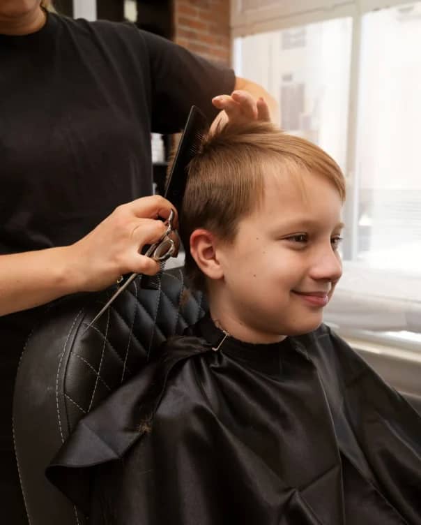 kid-getting-haircut-salon-side-view (1)