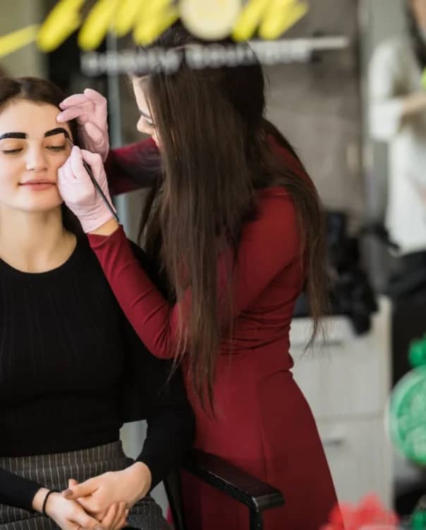 two-girls-are-doing-make-up-front-big-professional-mirror